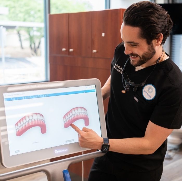 Doctor Raiffe pointing to digital models of teeth on computer monitor