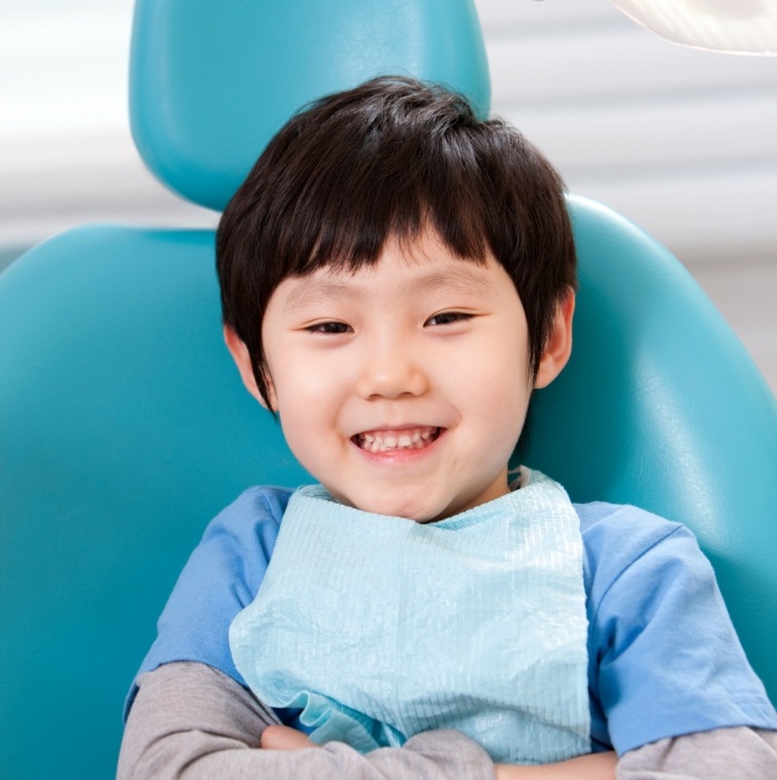 Smiling young boy in dental chair visiting childrens dentist in Scottsdale
