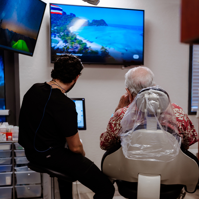 Dentist and patient looking at computer monitor together
