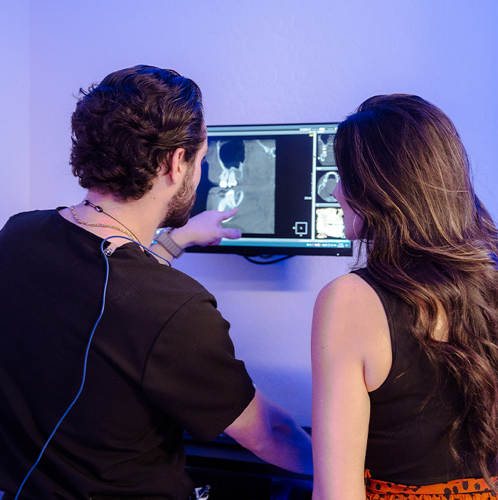 Doctor Raiffe showing a patient X rays of their teeth
