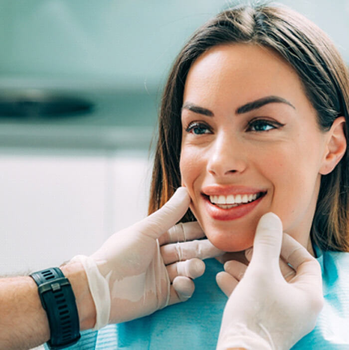 patient smiling while visiting dentist