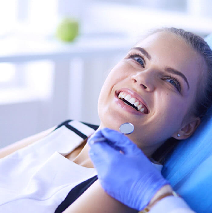 patient smiling while visiting dentist