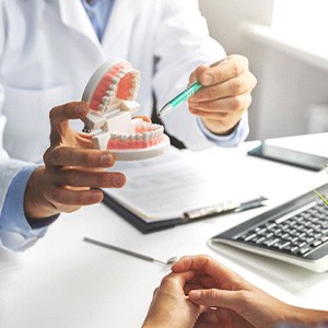 A dentist explaining implant treatment to a patient
