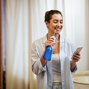 Invisalign patient flossing with water flosser