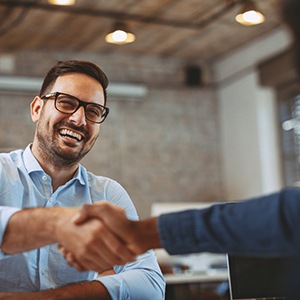 Invisalign patient shaking hands at work