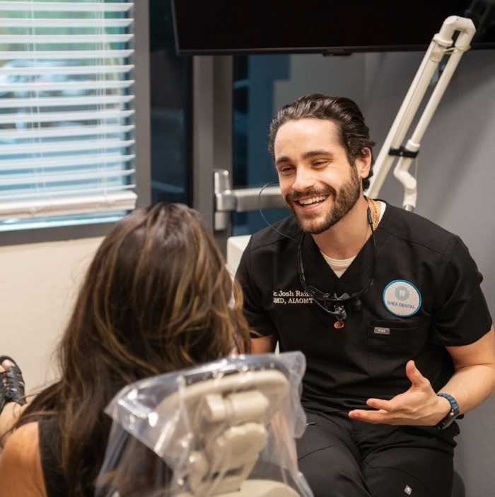 Doctor Raiffe smiling at dental patient