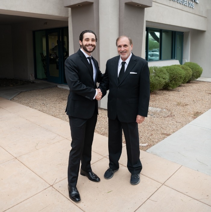 Doctor Raiffe and Doctor Siegel shaking hands in front of Shea Dental of Scottsdale