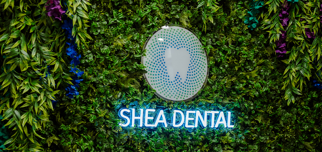 Shea Dental of Scottsdale logo in green bushes