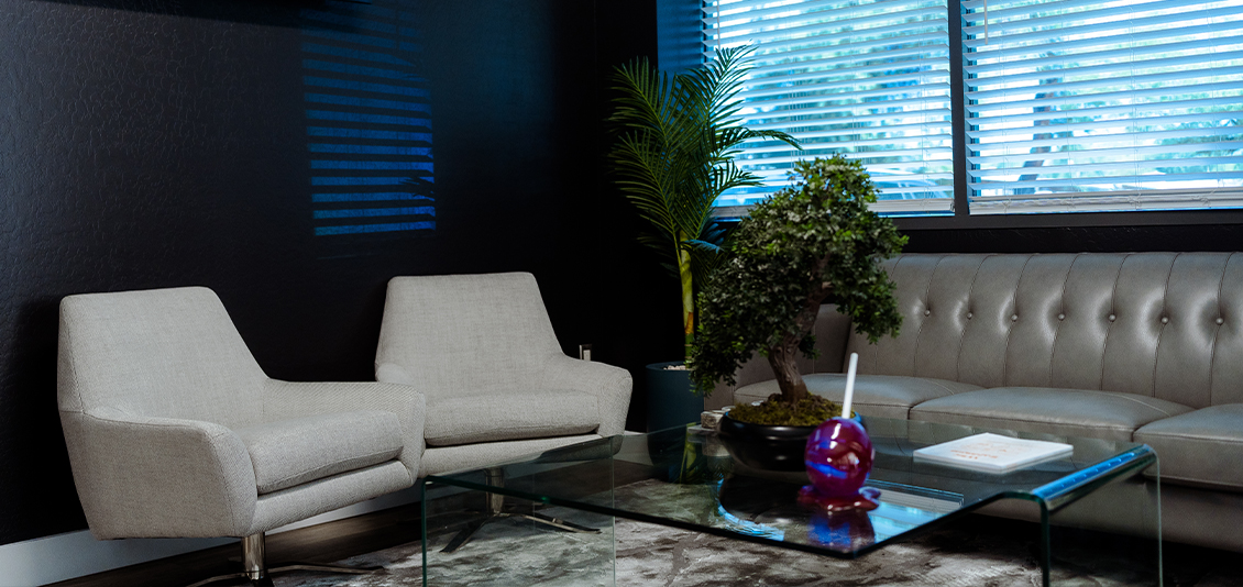 Leather couch and white chairs in reception area