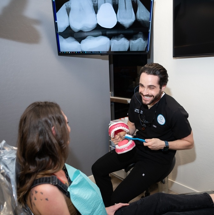Doctor Raiffe brushing model of teeth during preventive dentistry checkup in Scottsdale