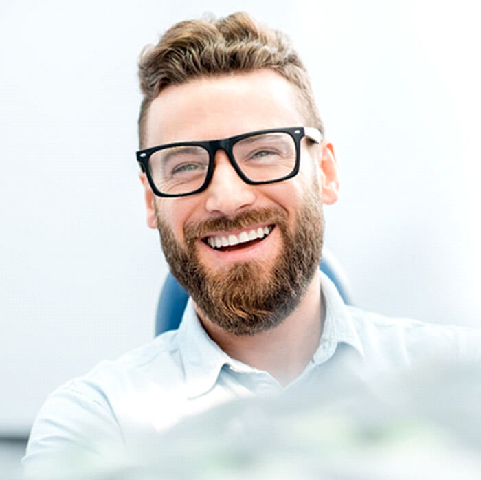 closeup of man smiling while sitting in treatment chair